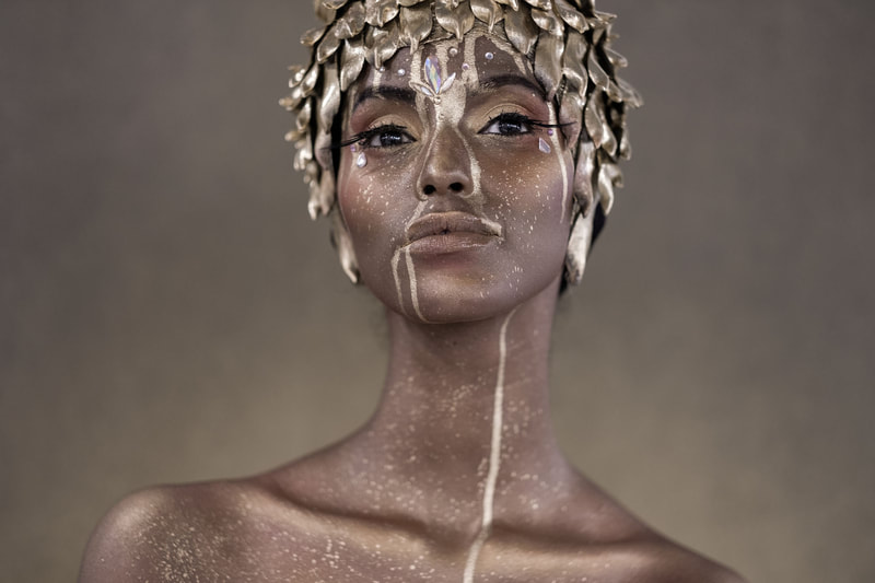 a photo of a woman covered in gold taken by Leon Oosthuizen on the X-H1 Fujifilm camera